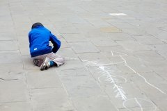 Child drawing in the street